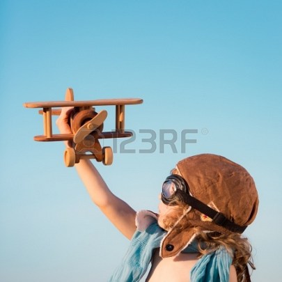 19761822-happy-kid-playing-with-toy-airplane-against-blue-summer-sky-background